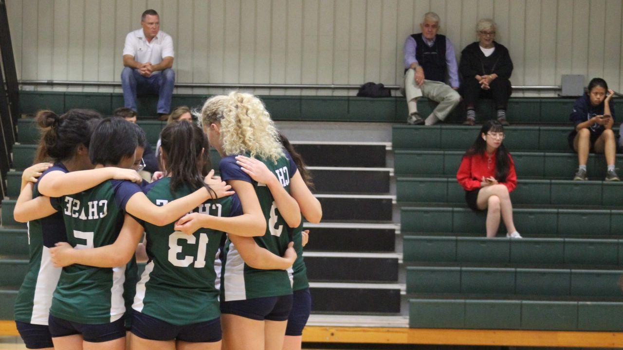 Gilrs Varsity Volleyball Chase Collegiate Huddles During Their Match.jpg